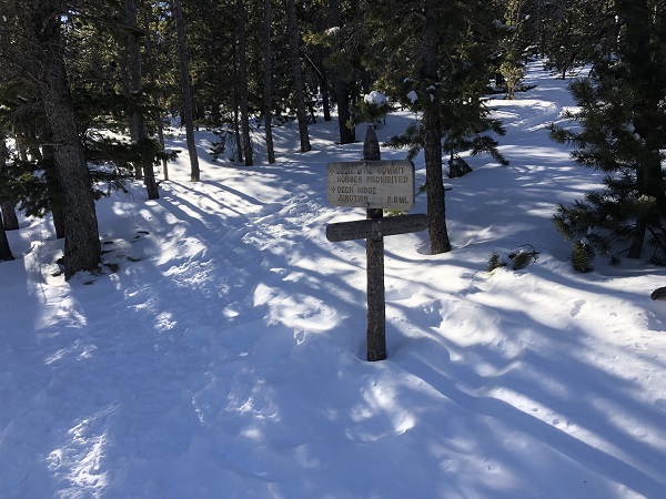 Hike to summit in Rocky Mountain National Park in snow.
